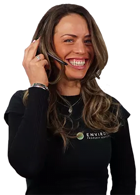 Woman smiling and wearing a headset, representing customer service for Environ Drainage Services, emphasizing accessibility and support for emergency drainage solutions.